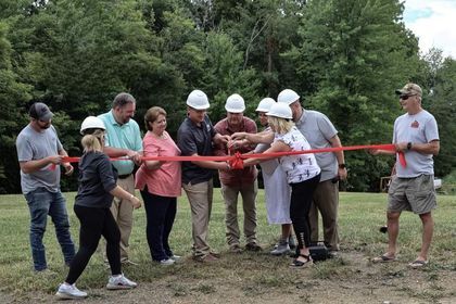 The Woodlands subdivision hosts groundbreaking and ribbon cutting ceremony